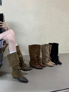 Detailed view of French pointed toe western cowboy mid-calf slouch boots, stylish footwear.