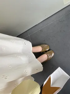 Detail view of olive green flat ballet shoes featuring square toe and cute bow detail.