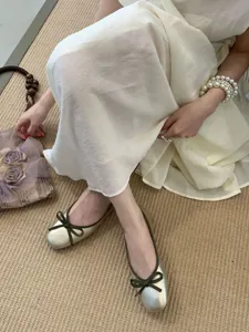 Detail view of the French square toe flat ballet shoes featuring a chic bow and metallic finish.