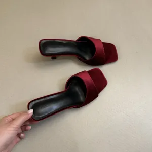 Red velvet square toe high heel mule sandal detail view showcasing smooth texture and classy design.