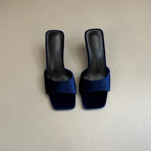 Velvet square toe high heel mules detail showing elegant dark blue fabric and fine heel design.