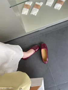Burgundy square toe flat ballet shoes detail shot showcasing soft leather and dainty bow tie.