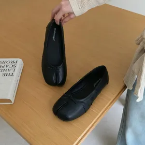 Black split-toe ballet flats, comfortable slip-on low-cut shoes with cute bow detail.