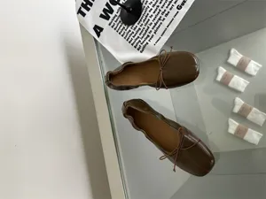 Detail shot of vintage brown square toe flat ballet shoes with soft leather upper.