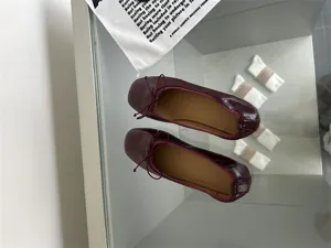 Burgundy leather flat ballet shoes detail showing soft upper texture and elegant round toe design.
