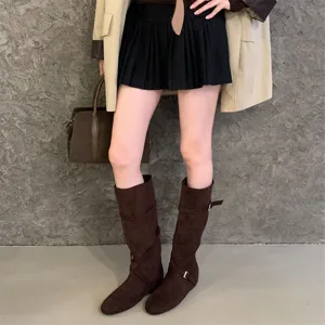 Retro suede slouchy long boots with cross buckle details and comfortable hidden wedge heel.