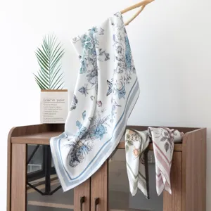 Elegant silk scarf with blue floral butterfly print, perfect stylish accessory for women.