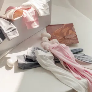 Detail shot of long silk sun protection gloves in assorted pastel colors, fine knit.