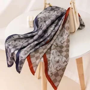 Luxurious silk printed square scarf with stylish checkered pattern and elegant color block edge.