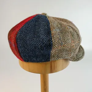 Detailed close-up of the vintage patchwork tweed newsboy flat cap texture and autumn design.