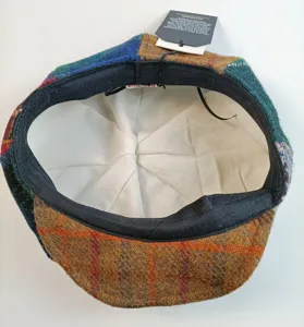 Close-up detail view showing the interior white lining and authentic wool patchwork flat cap tag.