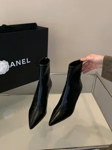 Detalle de elegantes botines negros de tacón alto y punta fina para la temporada.