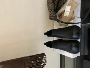 Black chunky chelsea boots detailed view, classic retro ankle boots with thick lug sole.