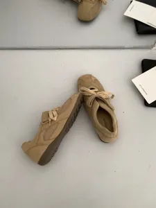 Beige suede casual sneakers detail, lace-up and velcro strap, comfortable daily wear shoes.