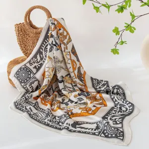 Silk scarf detail view showing intricate jungle animal print and elegant geometric border design.