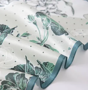 Premium silk scarf detail showcasing delicate lotus pattern and soft drape texture.