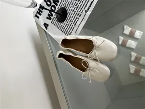 Retro beige flat ballet shoes for women, stylish shallow mouth design with cute bow knot.