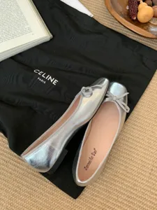 Silver metallic square toe ballet flats featuring delicate bow detail, close-up shoe detail view.
