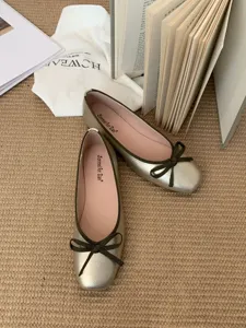 French square toe shallow bow flat ballet shoes, metallic gold upper with green ribbon bow detail.