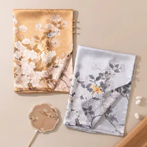 Close-up detail showing the exquisite Chinese style floral and bird print on the silk scarf.