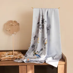 Close-up detail of the elegant double-layer silk long scarf with floral print and buckle.