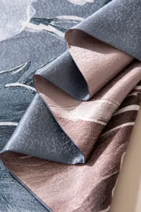 Silk scarf detail texture showing dual-layer snowflake satin fabric and abstract pattern.