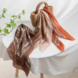 Close-up detail of the retro paisley cashmere scarf draped gracefully, elegant texture.