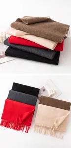 Detailed view of solid color cashmere scarves in multiple shades with fringe edges, warm winter wear.