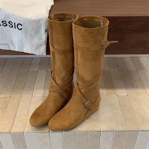 Stylish brown suede knee high boots featuring buckle straps and hidden wedge heel for daily wear.