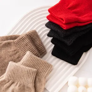 Close-up of pure cashmere knitted gloves in assorted colors, thick and warm for winter.