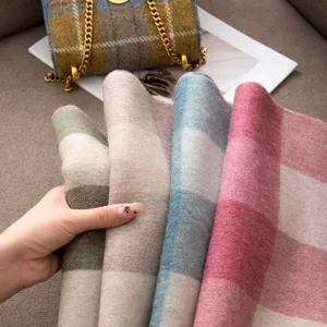 Detail shot of autumn winter plaid wool scarves showing multi-color soft texture and nice drape.