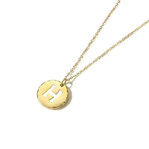 Detailed view of gold stainless steel initial letter H round pendant necklace charm.