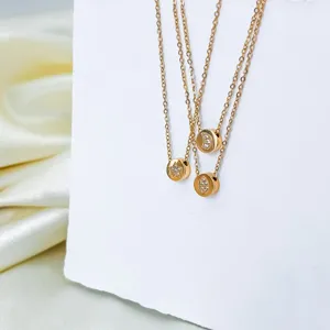 Stainless steel crystal star and moon pendant necklace detail, elegant gold jewelry accessory.