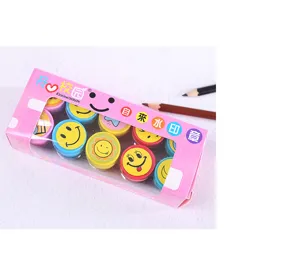 Detailed view of colorful cartoon smiley face self-inking stamps inside a pink box.