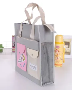 Borsa tote in tela grigia per studenti con tasche multiple e rete laterale per uso quotidiano.