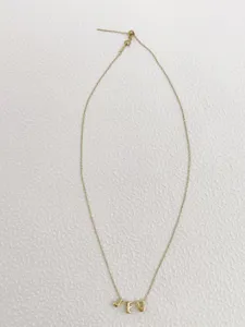 Delicate gold chain necklace featuring 3d bubble letter pendants spelling jeu for women.