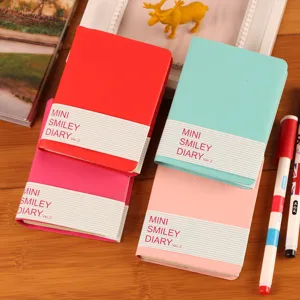 Mini cuaderno de bolsillo con cara sonriente, bloc de notas colorido para estudiantes y regalos.