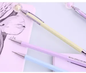 Close-up view of cute pastel mechanical pencil with 0.5mm lead and bear topper detail.