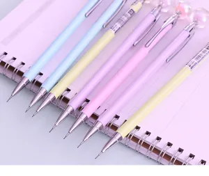 Detail shot of colorful metal mechanical pencils 0.5mm arranged on a pink planner notebook.