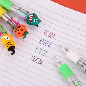 Close-up detail of cute Halloween multi-color ballpoint pens with cartoon monster and pumpkin toppers.