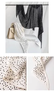 Silk scarf detail view, elegant black and white polka dot pattern, soft breathable fabric.