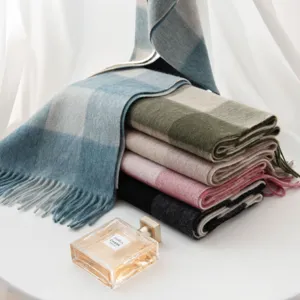 Detailed view of classic plaid pattern wool scarf with fringes, warm and stylish for winter.