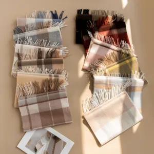 Classic plaid cashmere scarf, soft texture and fringe, ideal cozy winter accessory for daily wear.
