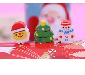 Cute Christmas eraser set featuring Santa, tree and snowman. Detail view of kids stationery.
