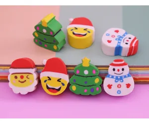 Close-up of cute cartoon Christmas tree and Santa eraser set, fun student stationery detail.