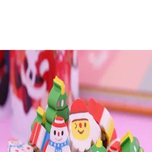 Close-up detail shot of cute Christmas cartoon erasers, including Santa and snowman shapes.
