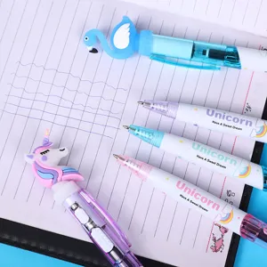Close-up detail of cute cartoon unicorn and flamingo luminous ballpoint pens on notebook.