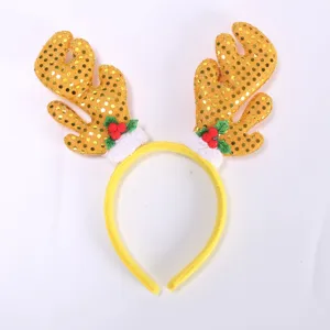 Close up view of the yellow sequin Christmas reindeer antler headband with berry decor details.