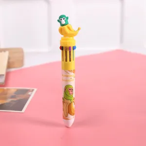 Funny cartoon monkey multicolor ballpoint pen detail view, cute student stationery item.