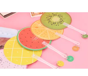 Detail view of cute cartoon fruit handheld fans with transparent handles and pendants.
